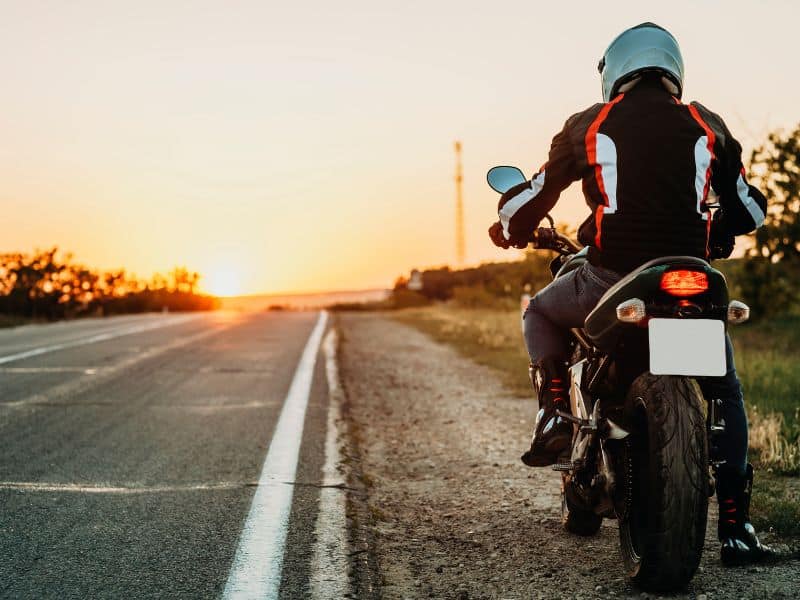 Photo of a motorcyclist pulled over on the side of the road